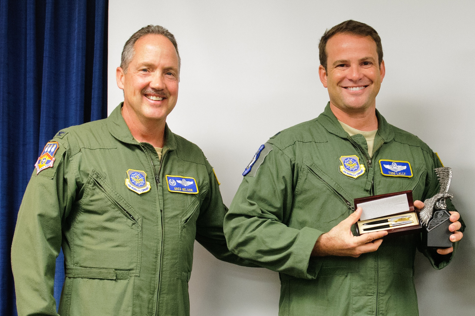 Col. Greg Nelson, commander of the 123rd Airlift Wing, presents Lt. Col. Todd Lally with the 2011 Air National Guard Outstanding Individual for Flight Safety Award during a ceremony at the Kentucky Air National Guard Base in Louisville, Ky., on May 19, 2012. Lally, chief of the wing safety office, earned the honor for his exceptional dedication to the safety community, according to the National Guard Bureau. (U.S. Air Force photo by Senior Airman Maxwell Rechel)