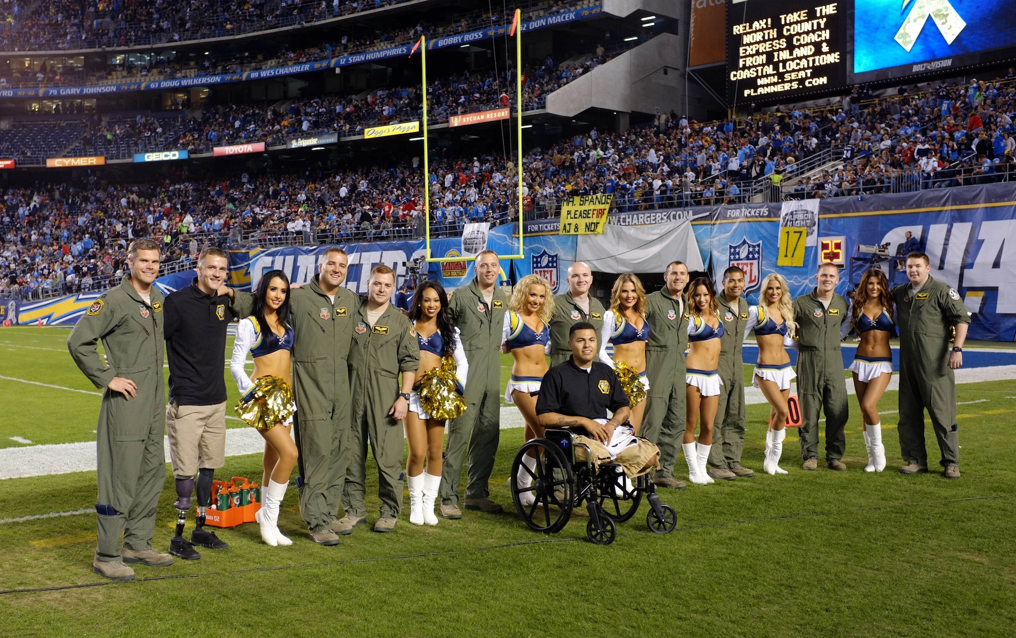 U.S. Air Force Airmen from the 391st Fighter Squadron, Mountain Home Air Force Base, Idaho, pose with wounded warriors and the San Diego Chargers cheerleaders Nov. 1, 2012, inside Qualcomm Stadium, San Diego, Calif. The aircrew members flew a four-jet flyover before the start of the nationally televised football game. (Courtesy photo)