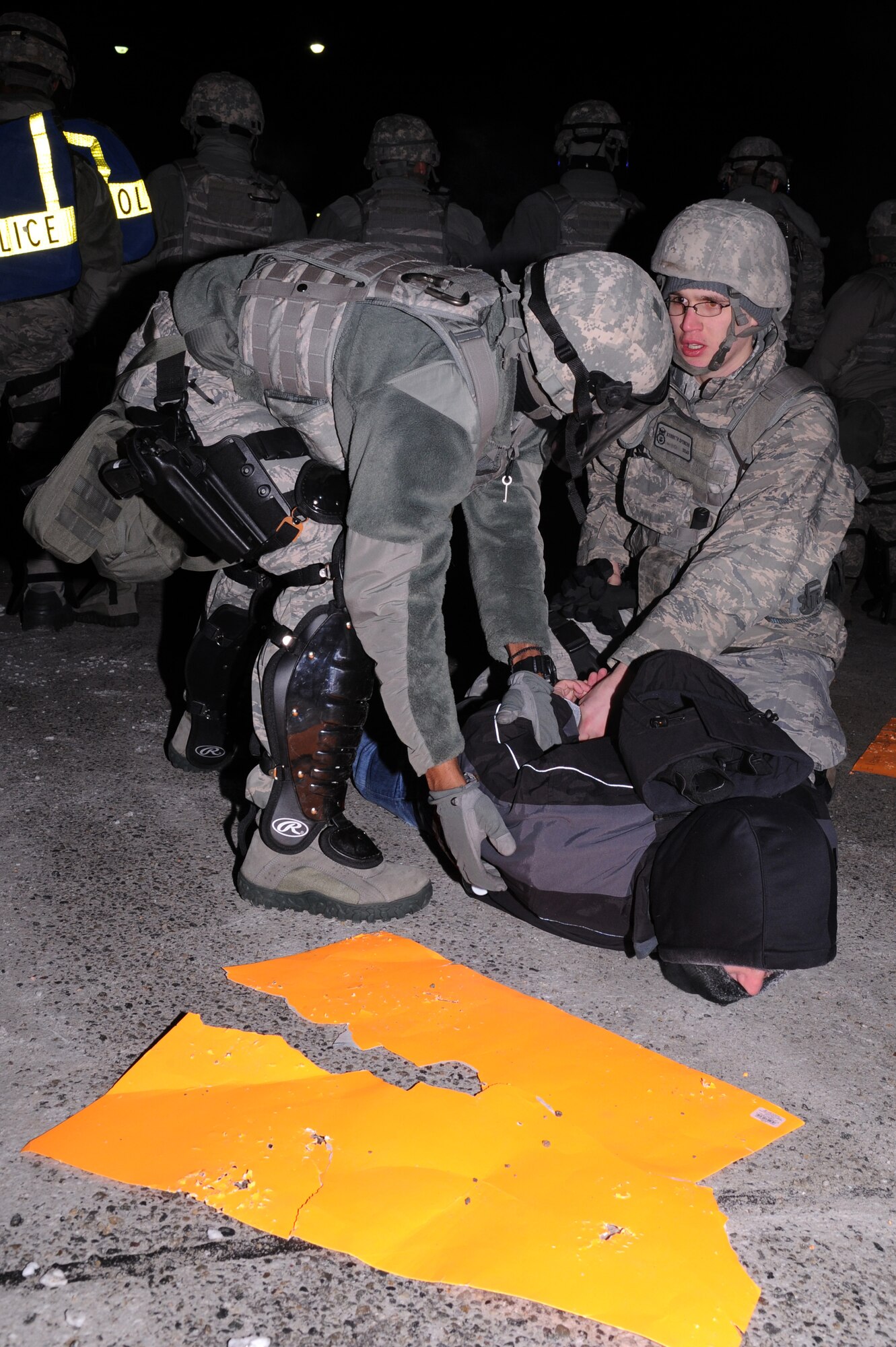Icemen assigned to the 354th Security Forces Squadron apprehend a suspect during an operational readiness exercise Nov. 7, 2012, Eielson Air Force Base, Alaska. During the ORE, Icemen assembled to stop a simulated protest from escalating into a riot. (U.S. Air Force photo/Staff Sgt. Jim Araos)
