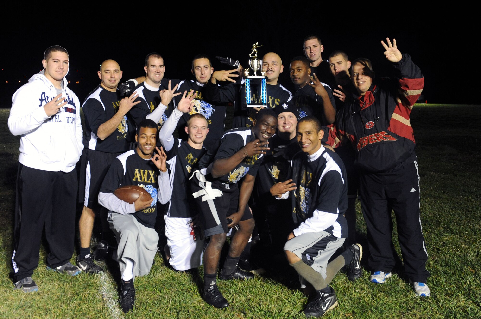 The 509th Aircraft Maintenance Squadron flag football team poses with the 2012 Flag Football championship trophy after defeating the Force Support Squadron 24-16, Nov. 13 at Whiteman Air Force Base, Mo. This is the third straight year AMXS has won the Flag Football Championship. (U.S. Air Force photo/Airman 1st Class Bryan Crane)