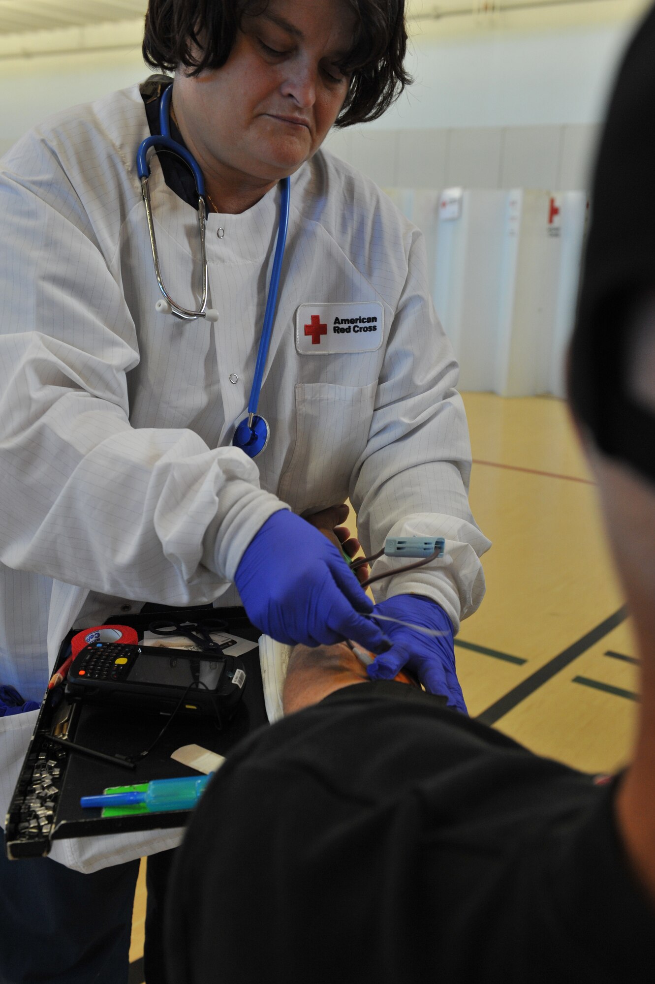 Linda Treat, American Red Cross lead-charge phlebotomist, prepares to take blood from Lynn Lowder, University of Central Missouri’s director of military and veteran services, during UCM’s Military Appreciation Blood Drive Nov. 9, in Warrensburg, Mo. UCM worked with the American Red Cross to sponsor the blood drive in honor of Veterans Day. (U.S. Air Force photo/Heidi Hunt) (Released)