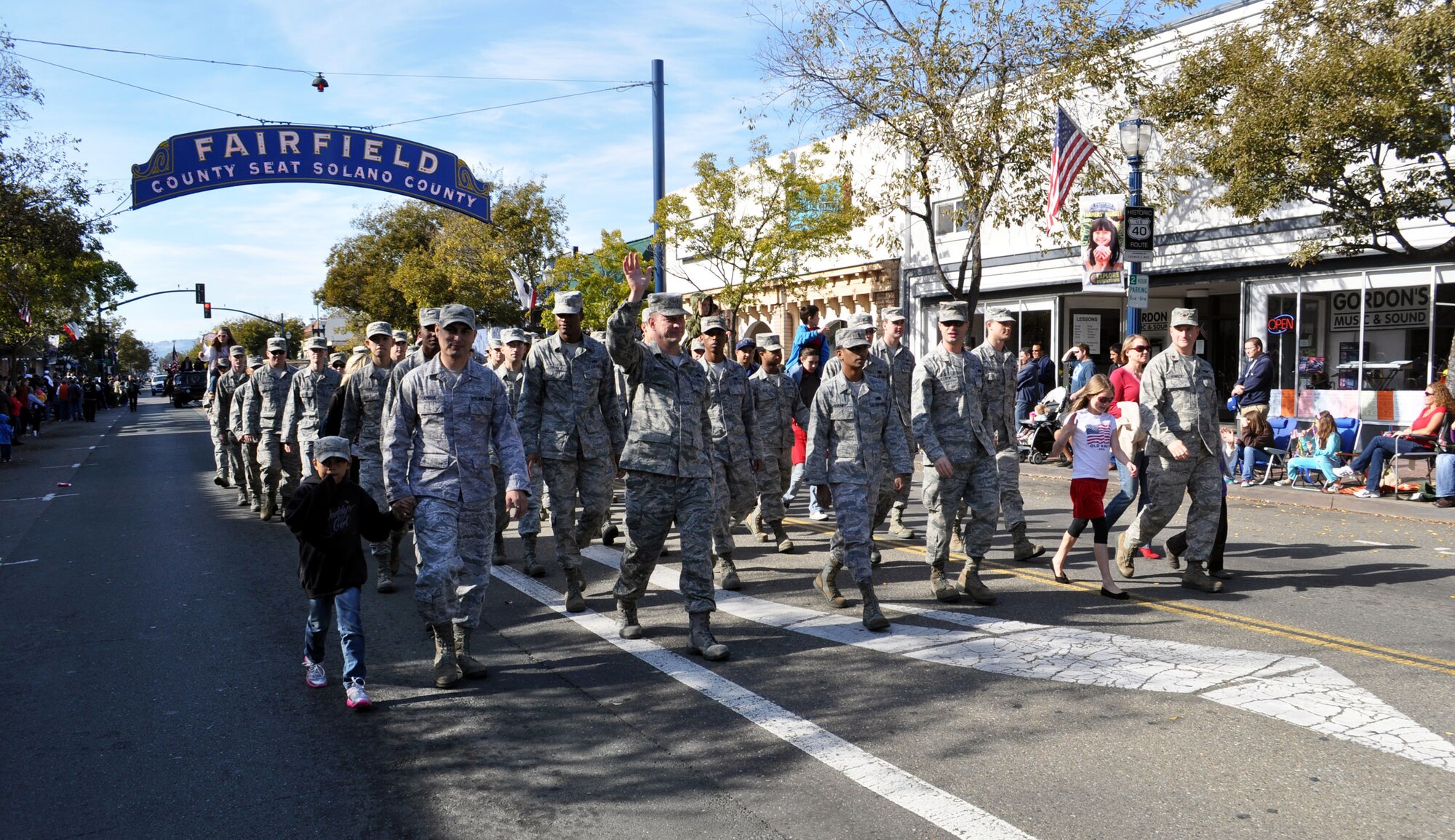 TRAVIS AIR FORCE BASE, Calif. -- A group of Airmen and their families from Travis Air Force Base walk in the 2012 Fairfield Veterans Day Parade. (U.S. Air Force photo/Senior Master Sgt. Ellen Hatfield)