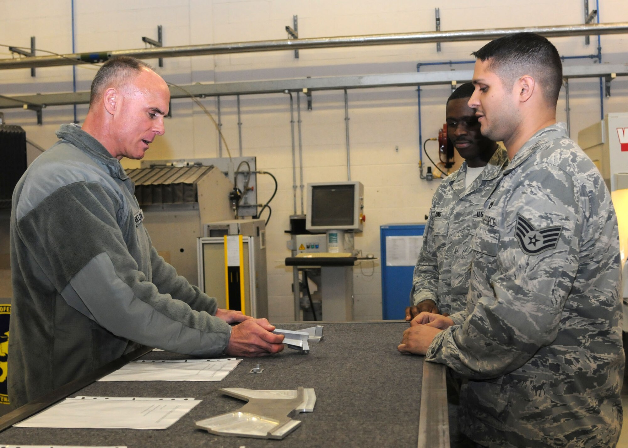 Lt. Gen. Craig A. Franklin, 3rd Air Force commander, Ramstein Air Base, Germany, speaks to Staff Sgt. David Irsern, 100th Maintenance Squadron aircraft metals technology craftsman, Nov. 15 2012, in building 814 on RAF Mildenhall, England. While here, Franklin met with base leadership and Airmen at a breakfast, briefings and lunch. The visit included tours of the 100th Civil Engineer Squadron Fire Department, 100th Logistics Readiness Squadron Fuels Processing, 100th Maintenance Group Sheet Metal, 100th Operations Group  and a static display of a KC-135 Stratotanker. While in England, the general also visited  RAF Fairford, RAF Croughton, RAF Welford, RAF Lakenheath and the Cambridge American Cemetery at Madingley. (U.S. Air Force photo by Airman 1st Class Kelsey A. L. Waters /Released)