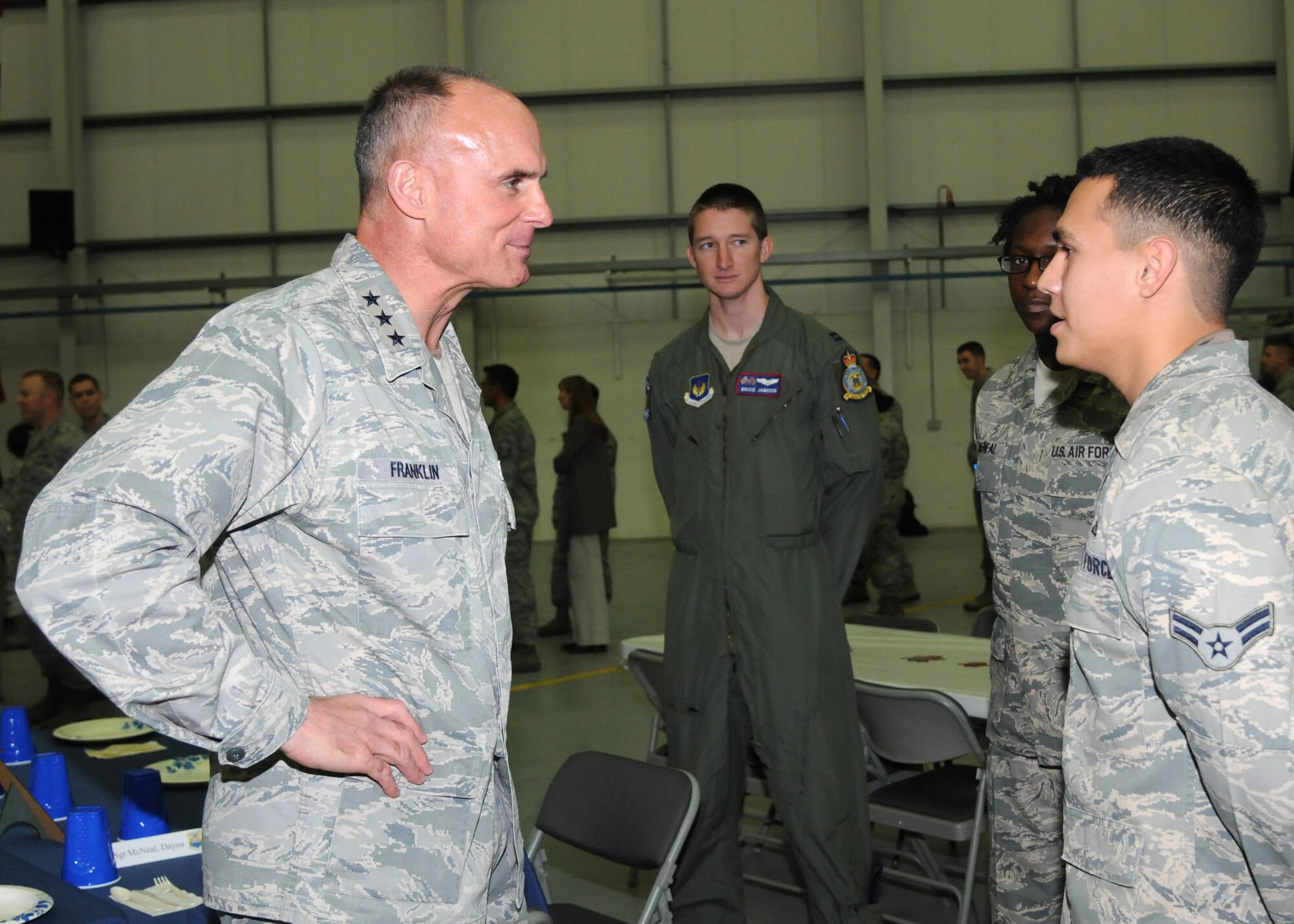 Airman 1st Class Michael Lara, 100th Operations Support Squadron aircrew flight equipment apprentice, speaks to Lt. Gen. Craig A. Franklin, 3rd Air Force commander, Ramstein Air Base, Germany, Nov. 15, 2012, in building 814 on RAF Mildenhall, England. While here, Franklin met with base leadership and Airmen at a breakfast, briefings and lunch. His visit included tours of the 100th Civil Engineer Squadron Fire Department, 100th Logistics Readiness Squadron Fuels Processing, 100th Maintenance Group Sheet Metal, 100th Operations Group and a static display of a KC-135 Stratotanker. While in England, the general also visited, RAF Fairford, RAF Croughton, RAF Welford, RAF Lakenheath and the Cambridge American Cemetery at Madingley. (U.S. Air Force photo by Airman 1st Class Kelsey A. L. Waters/Released)