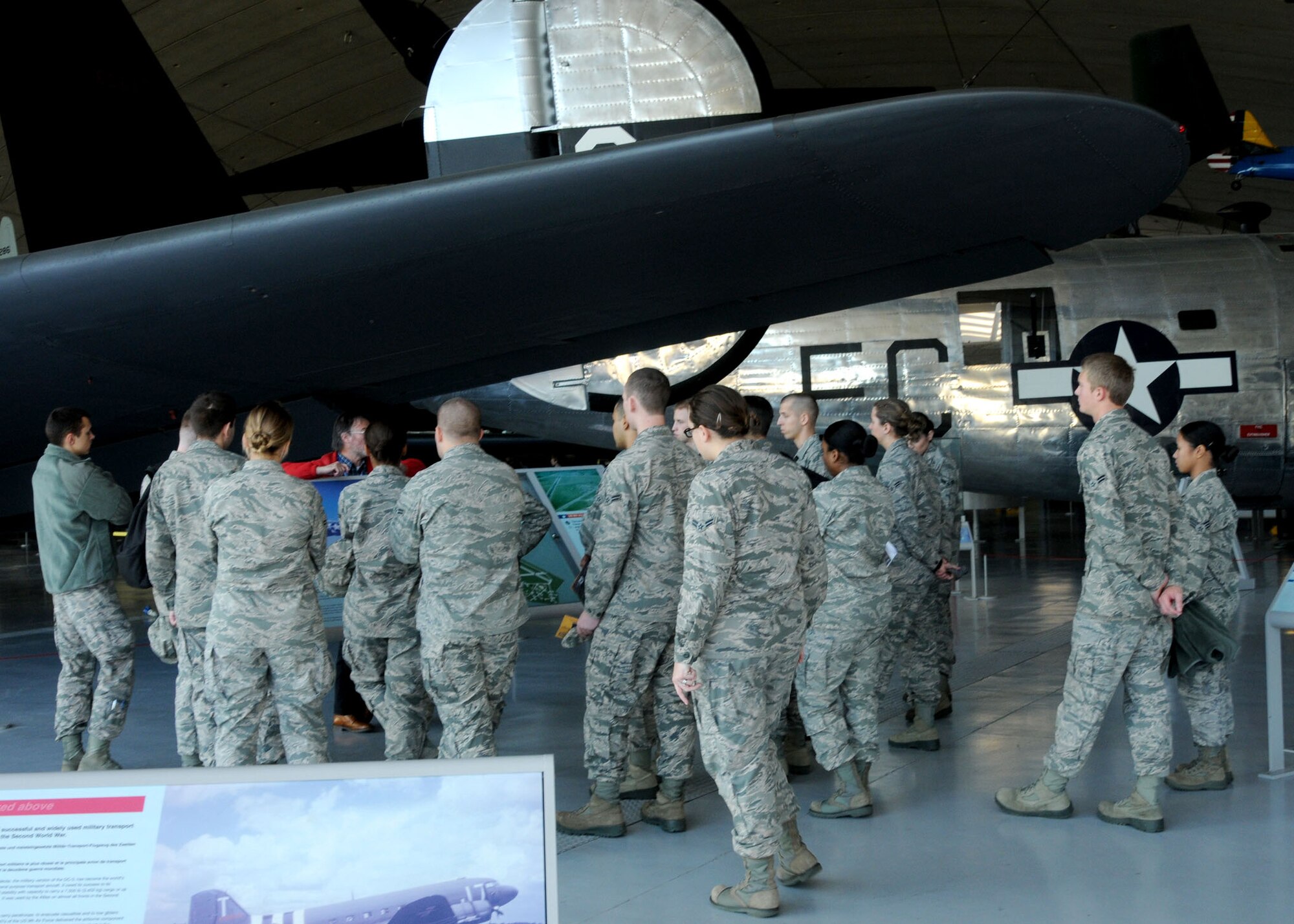 Airmen from RAF Mildenhall’s First Term Airmen’s Center listen as Ivor Warne, Duxford Imperial War Museum curator, explains the way flight crews worked during World War II Nov. 15, 2012, in Cambridgeshire, England. The Airmen went to the museum while in FTAC to get a lesson on U.S. Air Force history. (U.S. Air Force photo by Airman 1st Class Kelsey A. L. Waters/Released)