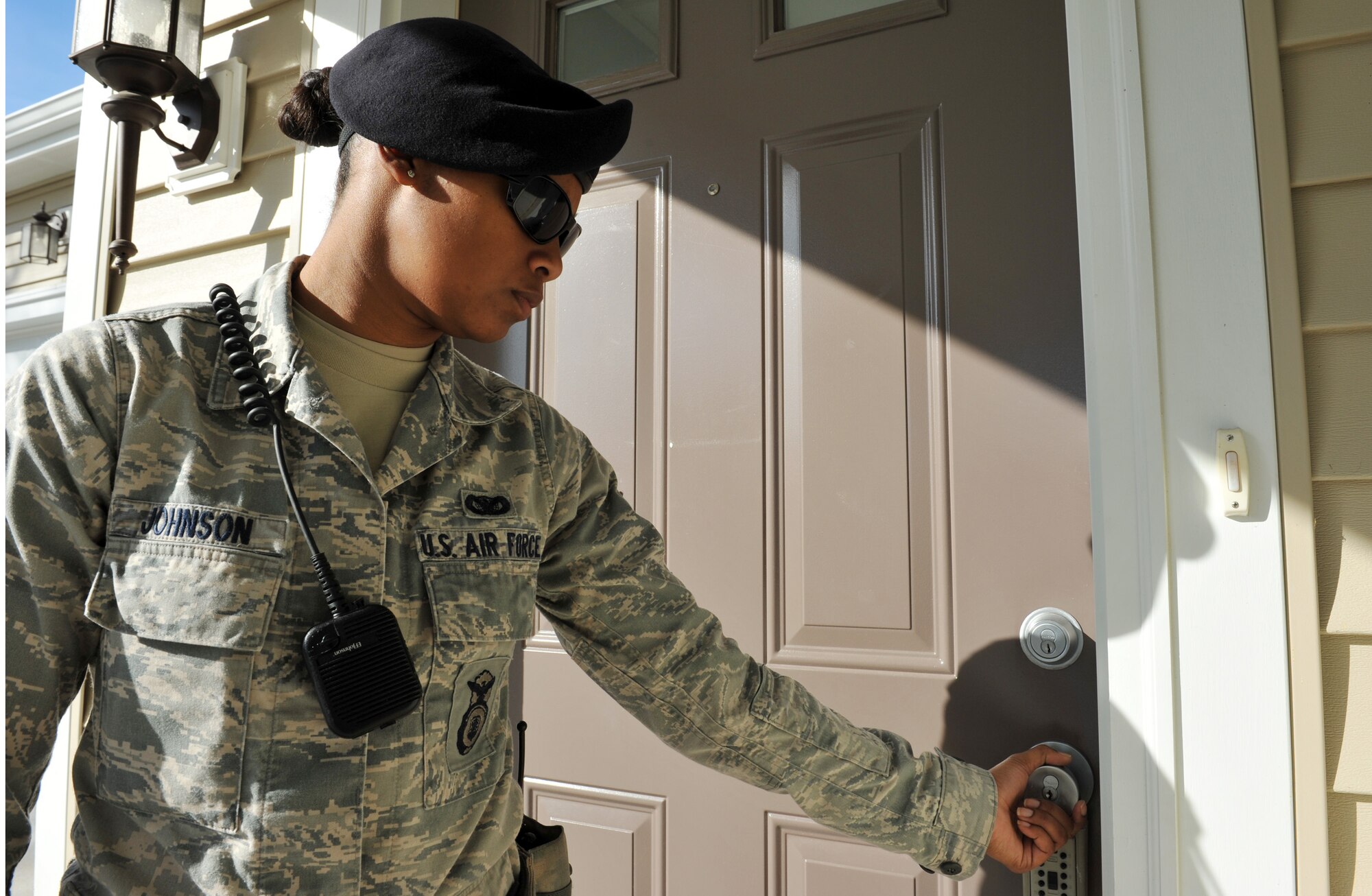 Senior Airman Keena Johnson, 509th Security Forces Squadron Law Enforcement, checks the front door at a base home at Whiteman Air Force Base during her shift Nov. 13. As part of Operation Quarters Watch, the 509th SFS will perform physical checks of the home and will notify the Law Enforcement Desk and the resident is  something is out of the ordinary. (U.S. Air Force photo/Heidi Hunt) (Released)  