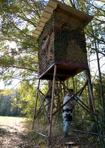 Staff Sgt. David Wales and Airman 1st Class Michael Meserole, 2nd Security Forces Squadron game wardens, inspect a deer stand on the East Reservation of Barksdale Air Force Base, La., Nov. 14. The base has six game wardens who are responsible for 18,000 acres of recreational hunting and fishing land. (U.S. Air Force photo/Staff Sgt. Chad Warren)(RELEASED)