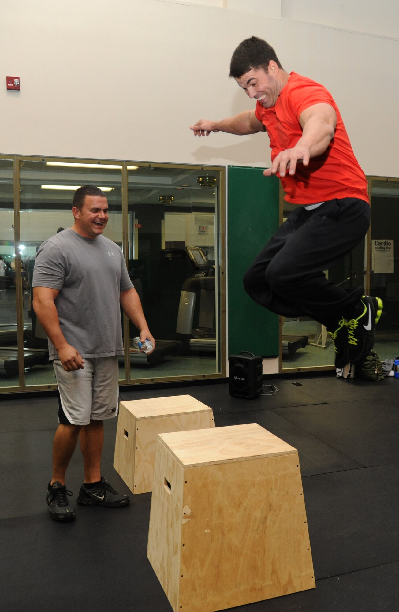 Master Sgt. Jamie Sieloff, 403rd Wing, provides technical support to Tech. Sgt. Joshua Lemoine, 403rd Wing, as he demonstrates how the box jump exercise is performed during the grand opening ceremony for the Warfighter Fitness Court Nov. 14, 2012, at the Dragon Fitness Center, Keesler Air Force Base, Miss.  The Warfighter Fitness Court provides fitness enthusiasts with a new alternative to traditional fitness training that is fully customizable for any experience level and designed to enhance strength and conditioning.  (U.S. Air Force photo by Kemberly Groue)