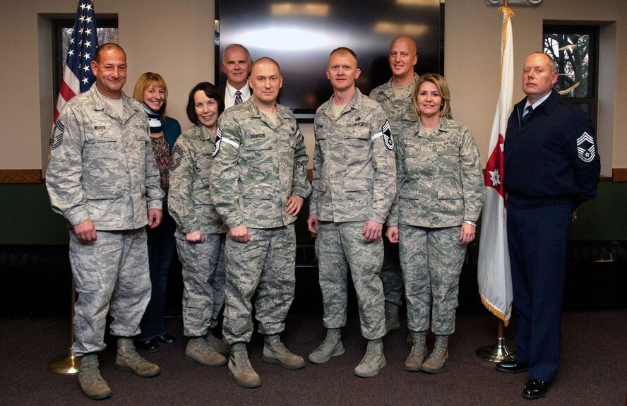 HANSCOM AIR FORCE BASE, Mass. -- Senior Master Sgts. Robert Johnson and Kevin Craig (center) are welcomed into the chief corps Nov. 9 at the Minuteman Commons during a chief-select celebration. Congratulating them after the ceremonial tacking of chief stripes are current and retired members of the Chief’s Group. (U.S. Air Force photo by Mark Herlihy)
