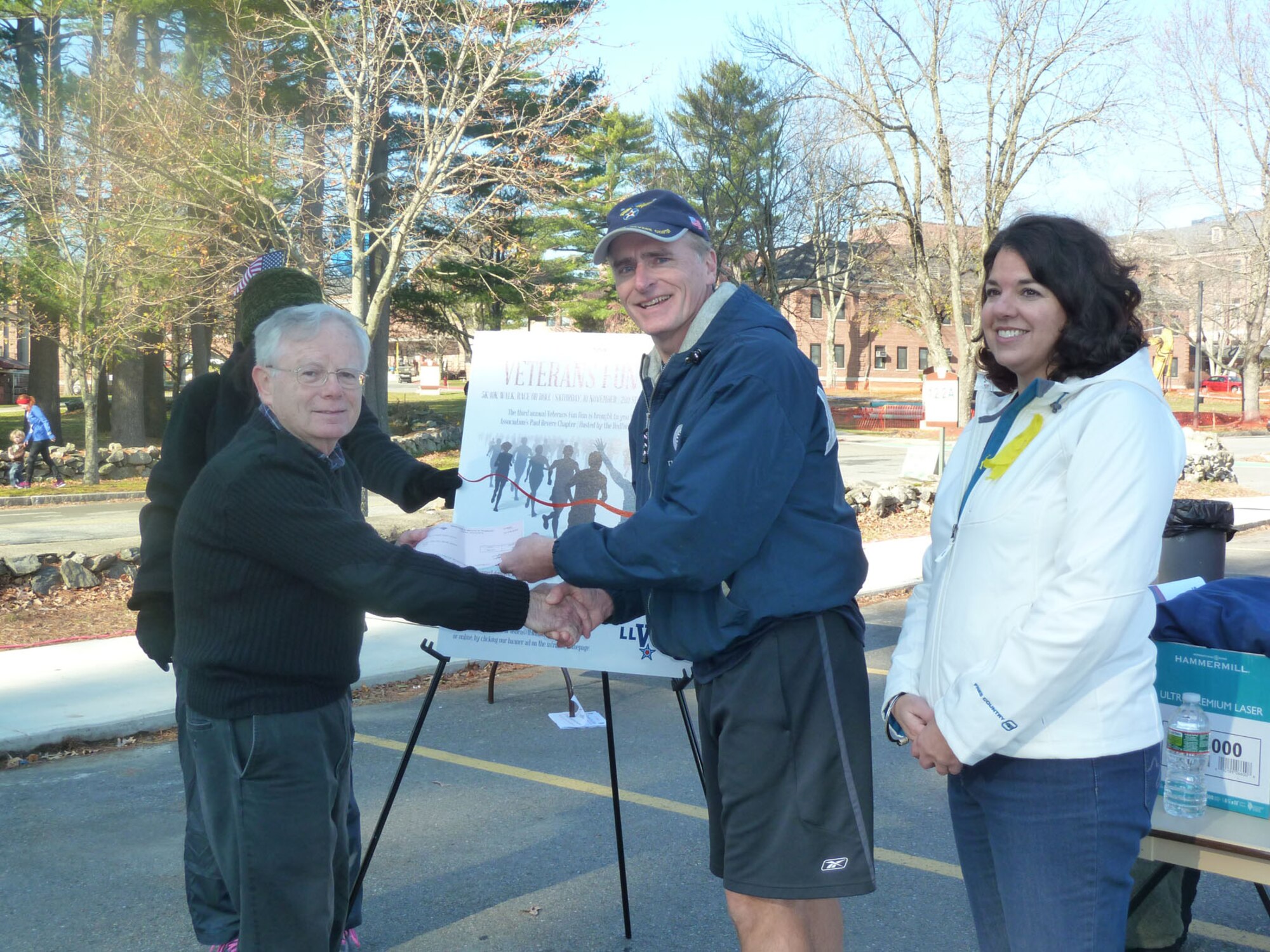 BEDFORD, Mass. - Dan O'Shea (left) of MIT Lincoln Laboratory presents a check to Keith Taylor, Air Force Association Paul Revere Chapter president, and Christine Croteau, Bedford VA acting director, during the Veterans Fun Run at the VA medical center Nov. 10. More than 350 runners and walkers participated in the third annual event to support veterans. (Courtesy photo) 