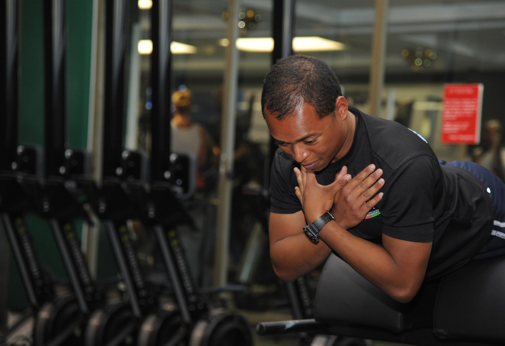 Senior Airman Thaddeus Faxon, 81st Contracting Squadron, performs a back extension demonstration during the grand opening ceremony for the Warfighter Fitness Court Nov. 14, 2012, at the Dragon Fitness Center, Keesler Air Force Base, Miss.  The Warfighter Fitness Court provides fitness enthusiasts with a new alternative to traditional fitness training that is fully customizable for any experience level and designed to enhance strength and conditioning. (U.S. Air Force photo by Kemberly Groue)
