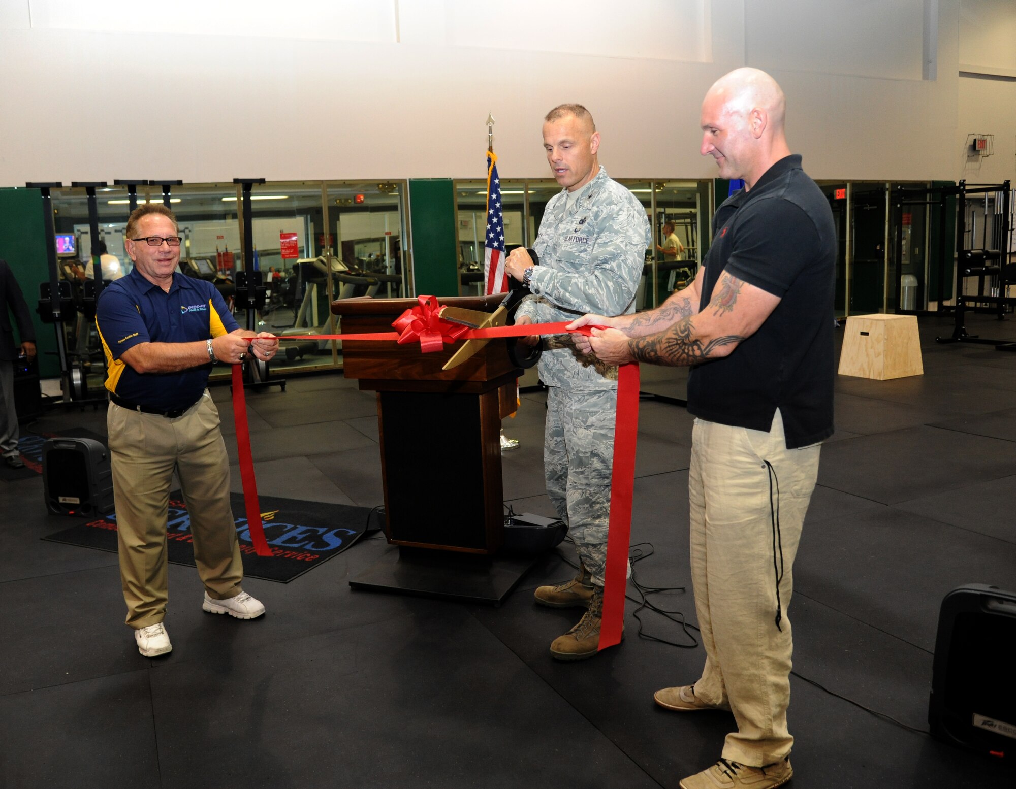 William Jinske, fitness services director, Brig. Gen. Brad Spacy, 81st Training Wing commander, and Al Ciampa, 81st Aerospace Medicine Squadron exercise physiologist, cut a ribbon during the grand opening ceremony for the Warfighter Fitness Court Nov. 14, 2012, at the Dragon Fitness Center, Keesler Air Force Base, Miss.  The Warfighter Fitness Court provides fitness enthusiasts with a new alternative to traditional fitness training that is fully customizable for any experience level and designed to enhance strength and conditioning.   (U.S. Air Force photo by Kemberly Groue)