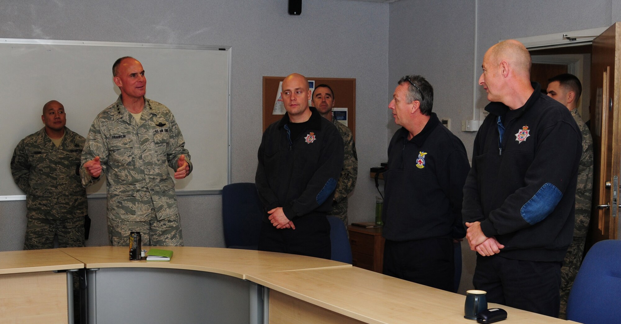 Lt. Gen. Craig A. Franklin, 3rd Air Force commander, Ramstein Air Base, Germany, coins Firefighter Simon Law, 100th Civil Engineer Squadron Fire Department Nov. 15, 2012,at RAF Mildenhall, England. Franklin recognized Law for his win as Civilian of the Quarter for 100th CES, 100th Air Refueling Wing and Team Mildenhall. While here, Franklin met with base leadership and Airmen at a breakfast, briefings and lunch. While in England, the general also visited RAF Fairford, RAF Croughton, RAF Welford, RAF Lakenheath and the Cambridge American Cemetery at Madingley. (U.S. Air Force photo by Karen Abeyasekere/Released)
