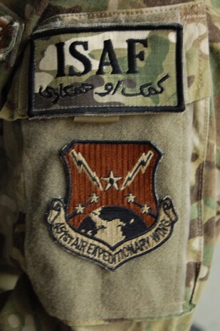 The International Security Assistance Force patch and the 451st Air Expeditionary Wing patch worn on the left arm of Senior Airman Lacy Porell, 166th Logistics Readiness Squadron, Delaware Air National Guard, at the New Castle ANG Base, Del., on Nov. 13, 2012. Airman Porell deployed to the 451st AEW at Kandahar Airfield, Afghanistan. She is one of 15 members of the 166th LRS who deployed for six-month long missions in 2012 for duty in the aerial ports at two airfields in Afghanistan and at one other base in Southwest Asia in support of Operation Enduring Freedom. (U.S. Air Force photo/Tech. Sgt. Benjamin Matwey)