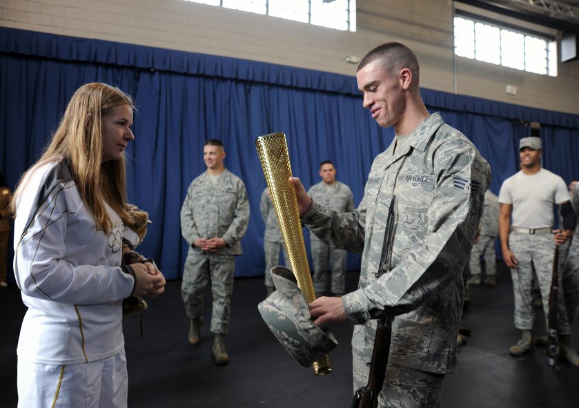 Bailey Reese shares her Olympic torch with members of the U.S. Air Force Honor Guard at Joint Base Anacostia-Bolling, D.C., Oct. 24.  Bailey is the president and founder of Hero Hugs, a non-profit organization that sends care packages to service members overseas.  (U.S. Air Force photo/Staff Sgt. Torey Griffith)