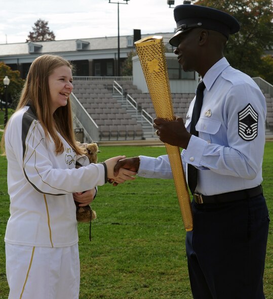 Bailey Reese shakes hands with Chief Master Sgt. Dennis Douglas, U.S. Air Force Honor Guard cheif enlisted manager, during her visit to the Honor Guard campus at Joint Base Anacostia-Bolling, D.C., Oct. 24.  Bailey was selected to run the Olympic torch to represent America at the 2012 Games in London. (U.S. Air Force photo/Staff Sgt. Torey Griffith)