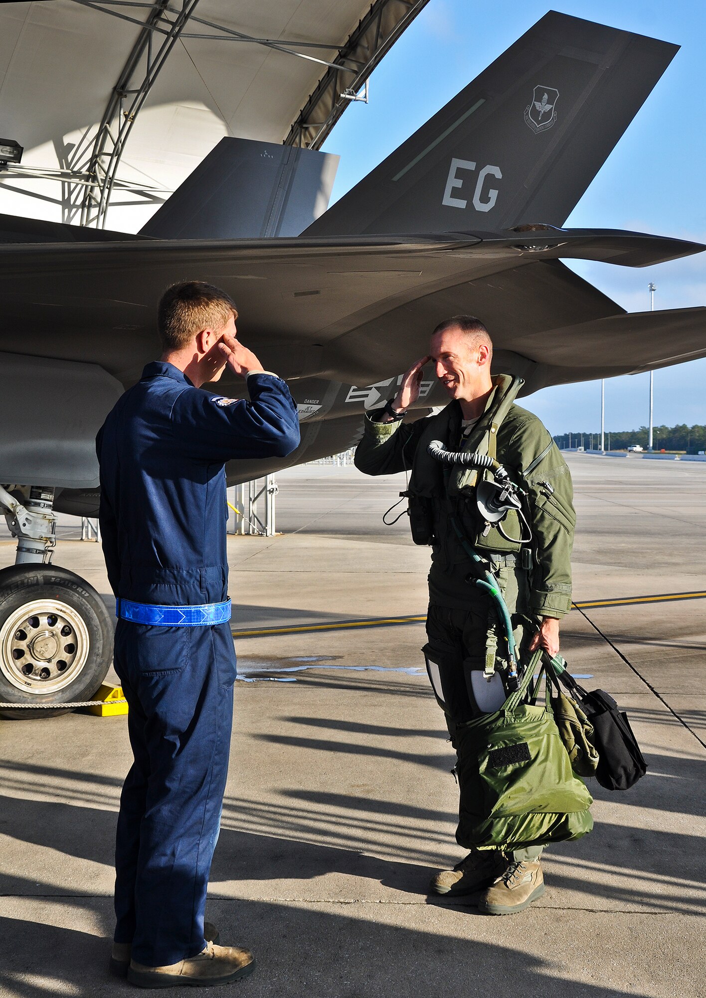 Lt. Col. Brian O'Neill, 31st Test and Evaluation Squadron director of operations and a "student" in the Air Force F-35A Lightning II Operational Utility Evaluation, salutes his crew chief before his postflight inspection Nov. 14 at Eglin Air Force Base, Fla.  He became qualified to fly the aircraft during the last sortie of the service’s evaluation of the 33rd Fighter Wing's joint strike fighter training program, a necessary review for Air Education and Training Command to decide if the unit is “ready for training” next year.  O’Neill will return to the 31st TES, a geographically separated unit of the 53rd Wing at Edwards AFB, Calif., where the Air Force will eventually begin operational testing on the new aircraft. (U.S. Air Force photo/Maj. Karen Roganov)