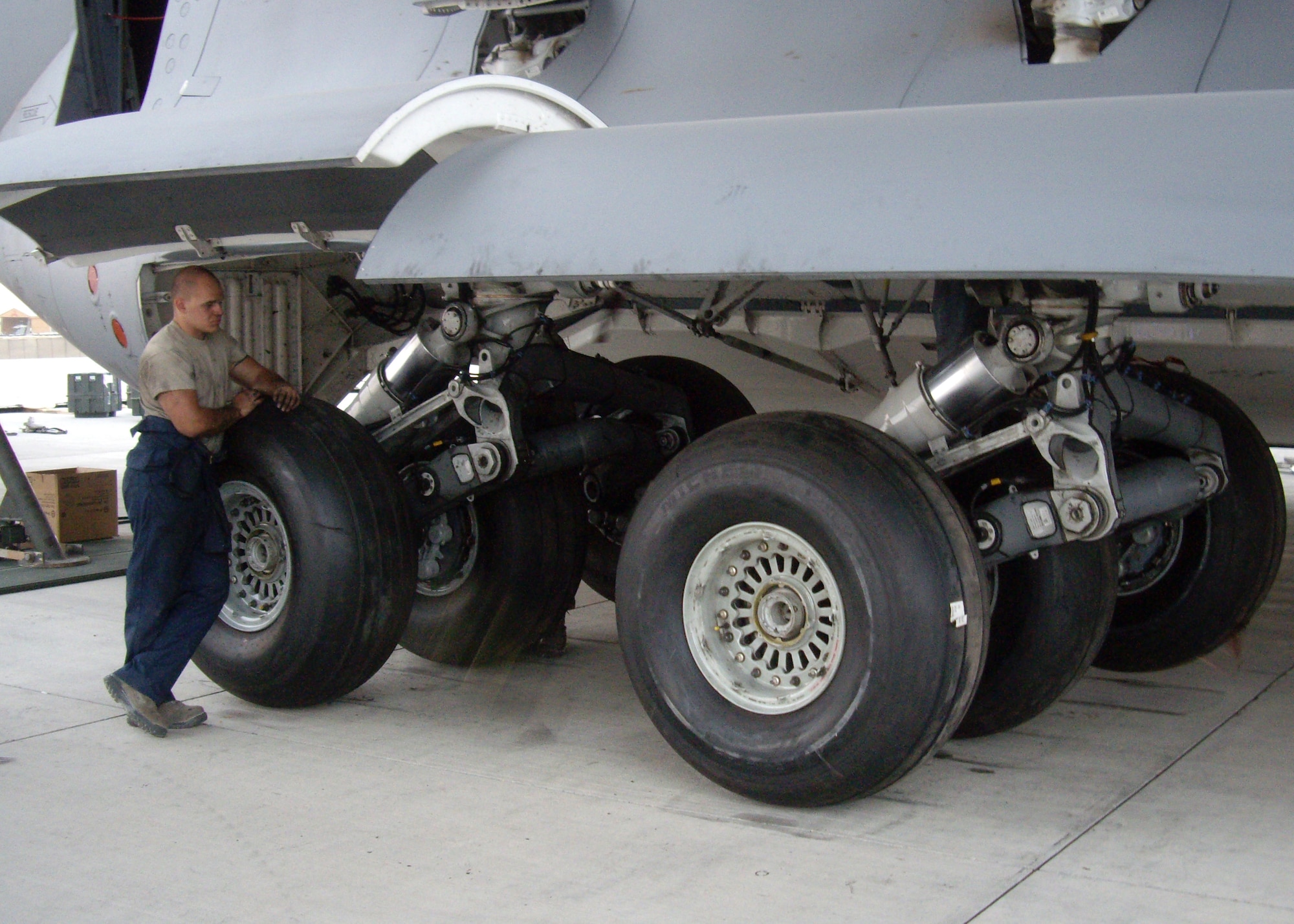 Senior Airman Andrew Fox, 8th Expeditionary Air Mobility Squadron mission recovery team member, is observing the completed work the seven-man MRT accomplished at Forward Operating Base Shank, Afghanistan, Sept. 14, 2012. The MRT, assigned to the 8th Expeditionary Air Mobility Squadron, completed the replacement of 12 main landing gear tires, eight main landing gear brakes and eight break temperature sensors on a downed C-17 Globemaster III. (U.S. Air Force courtesy photo)