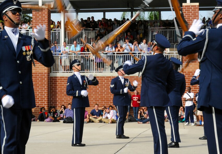 Members of the U.S. Air Force Honor Guard Drill Team toss their bayonette-tipped M-1 rifles during a performance at Mount Dora High School in Mount Dora, Fla., Nov. 12, 2012.   The Mount Dora High School JROTC drill team hosted the Air Force Honor Guard Drill Team in honor of Veteran's Day, and even treated them to dinner at the local Elks Lodge afterward.  (U.S. Air Force photo/Staff Sgt. Torey Griffith)