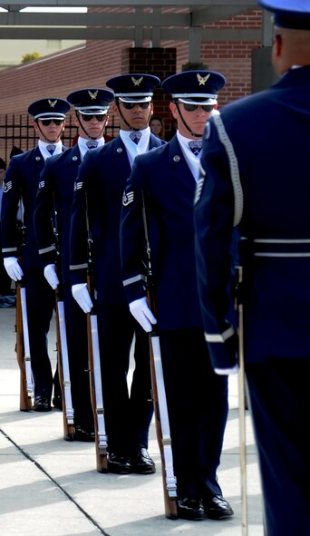 Members of the U.S. Air Force Honor Guard Drill Team prepare for the next drill sequence as students from Mount Dora High School watch them perform Nov. 12, 2012, in Mount Dora, Fla.  The Mount Dora High School JROTC drill team hosted the Air Force Honor Guard Drill Team in honor of Veteran's Day, and even treated them to dinner at the local Elks Lodge afterward.  (U.S. Air Force photo/Staff Sgt. Torey Griffith)