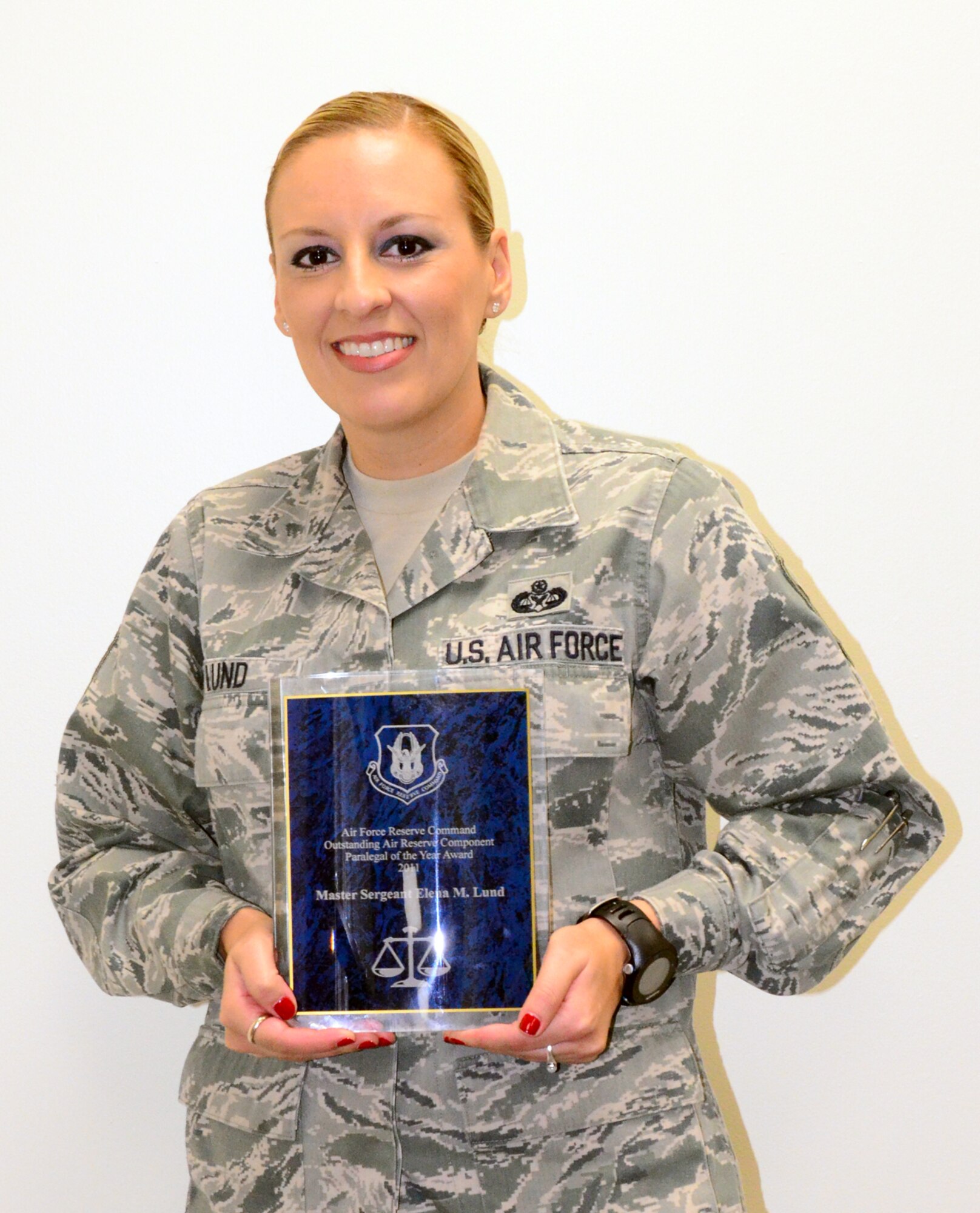 Master Sgt. Elena Lund, 94th Airlift Wing legal office superintendent, recently received the Air Force Reserve Command Outstanding Air Reserve Component Paralegal of the Year Award for 2011, also known as the David Westbrook Award. Lund was also presented a commander's coin for her accomplishments. (U.S. Air Force photo/Senior Airman Elizabeth Van Patten)