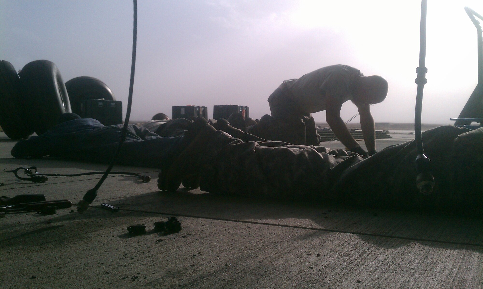 8th Expeditionary Air Mobility Squadron mission recovery team members hit the ground as incoming mortar rounds are fired toward Forward Operating Base Shank's flightline Sept. 14, 2012. The team forward deployed to Afghanistan to repair and recover a downed C-17 Globemaster III. (U.S. Air Force courtesy photo)