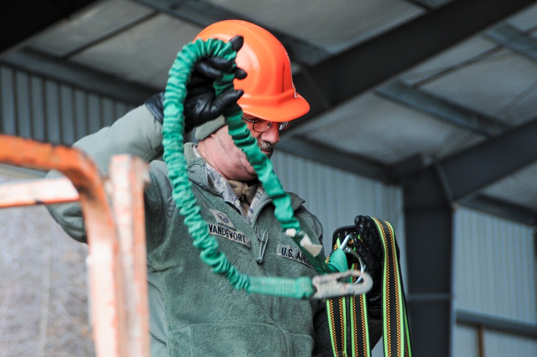 YOUNGSTOWN AIR RESERVE STATION, Ohio — U.S. Air Force Reserve Master Sgt. David M. Vandevort, skilled tradesman with 910th Civil Engineers here, dons a safety harness Nov. 14, 2012 before he begins work at the civil engineer training site here. The new training site will offer valuable training to civil engineer squadrons from several units, while adding usable training and exercise structures to YARS. Released/U.S. Air Force photo by Tech. Sgt. Brenda Cosola
