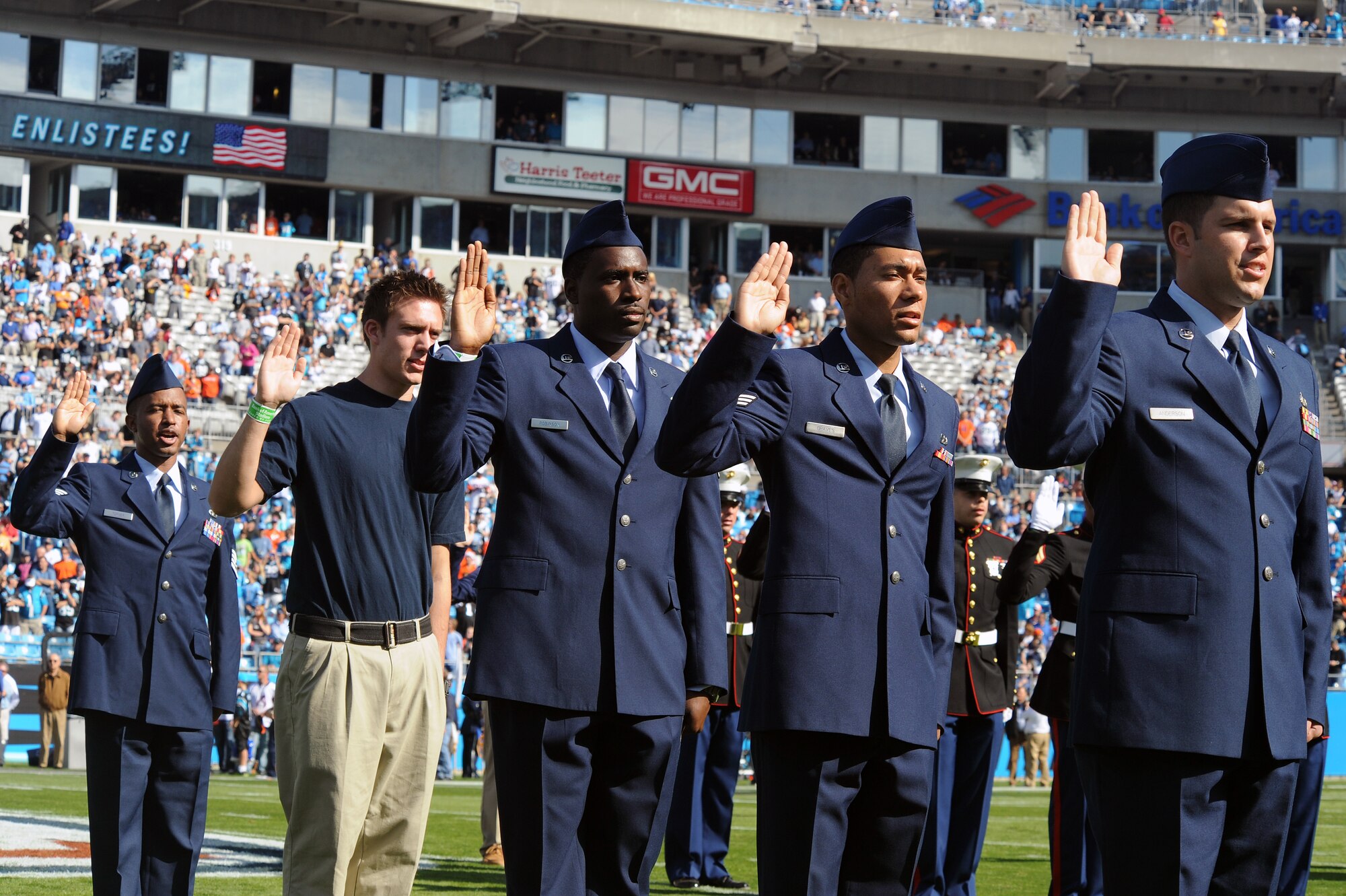 Four Airmen assigned to Seymour Johnson Air Force Base and a new recruit recite the Oath of Enlistment during a ceremony held at Bank of America Stadium in Charlotte, N.C., Nov. 11, 2012. In honor of Veteran’s Day, servicemembers from each branch of the military were selected to enlist and re-enlist prior to a Carolina Panthers football game.