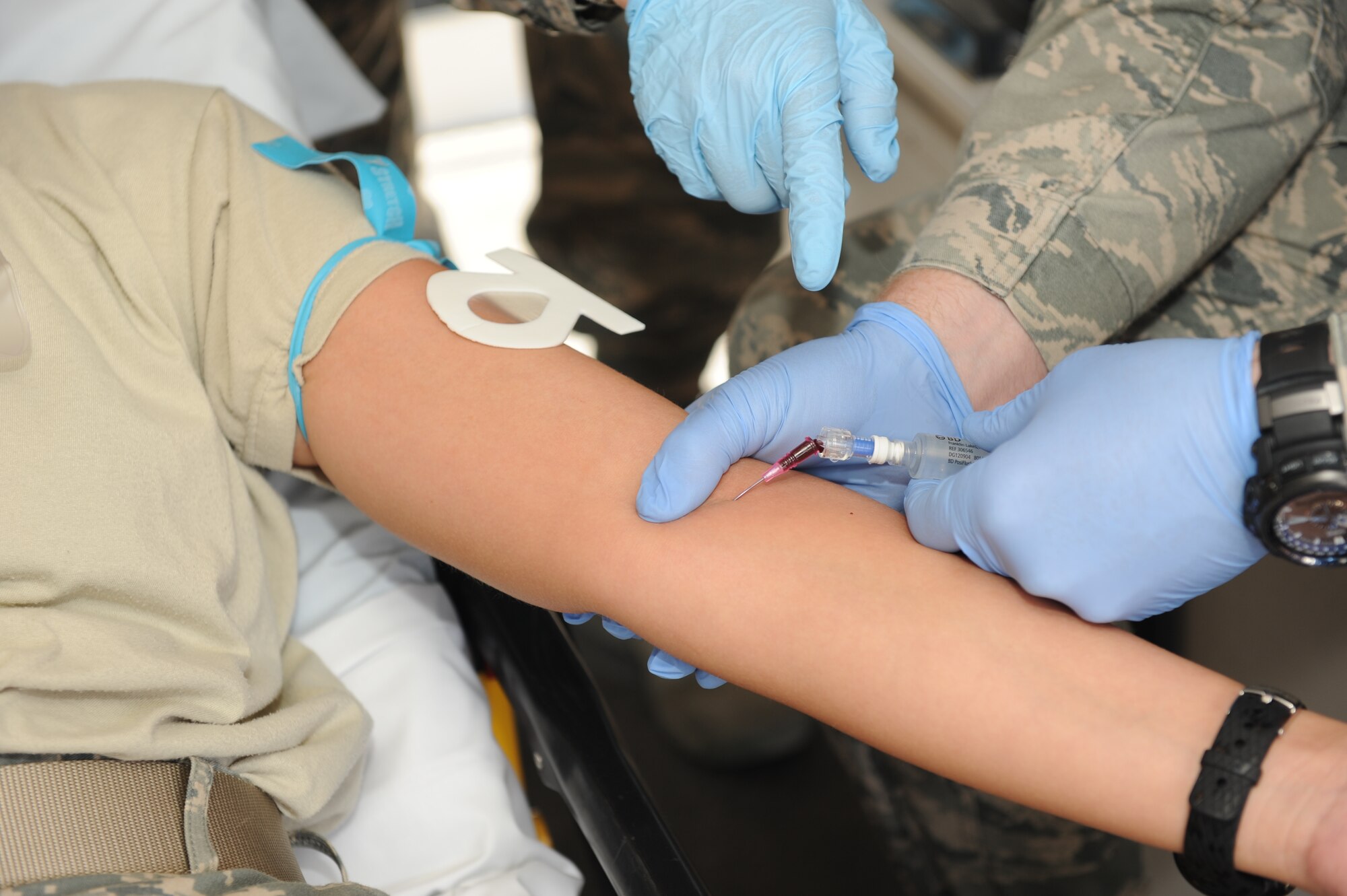 SOUTHWEST ASIA – Senior Airman Keith Libby, 379th Expeditionary Medical Group combat medical technician, gets a flash of blood as he readies the intravenously injected saline solution into his patient during a training exercise Nov. 14, 2012. When a needle is successfully inserted into a vein a “flash” of blood will enter the tubing. Libby is deployed from Joint Base Langley-Eustis, Va., and is a native of Apple Valley, Calif. (U.S. Air Force photo/Senior Airman Joel Mease)
