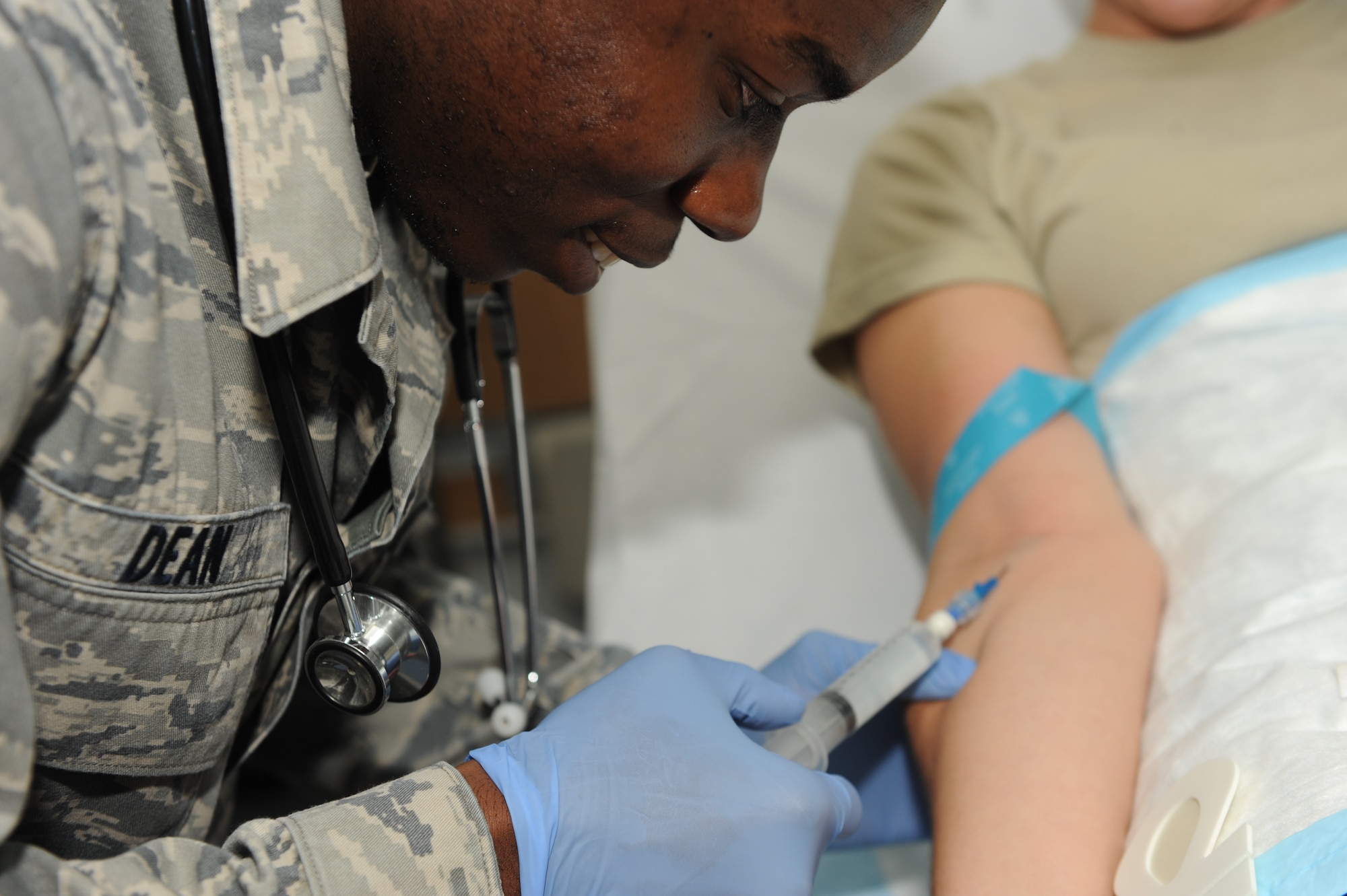 SOUTHWEST ASIA - Airman 1st Class Anthony Dean, 379th Expeditionary Medical Group combat medical technician, prepares to intravenously administer saline during a training exercise Nov. 14, 2012. A Combat Medic’s  responsibilities are vast and impact nearly all aspects in the hospital. Some of their duties include providing immunizations, assisting as an emergency medical technician, providing sutures for patients and conducting intravenous operations. Dean is deployed from Joint Base Langley-Eustis, Va., and is a native of Virginia Beach, Va. (U.S. Air Force photo/Senior Airman Joel Mease)