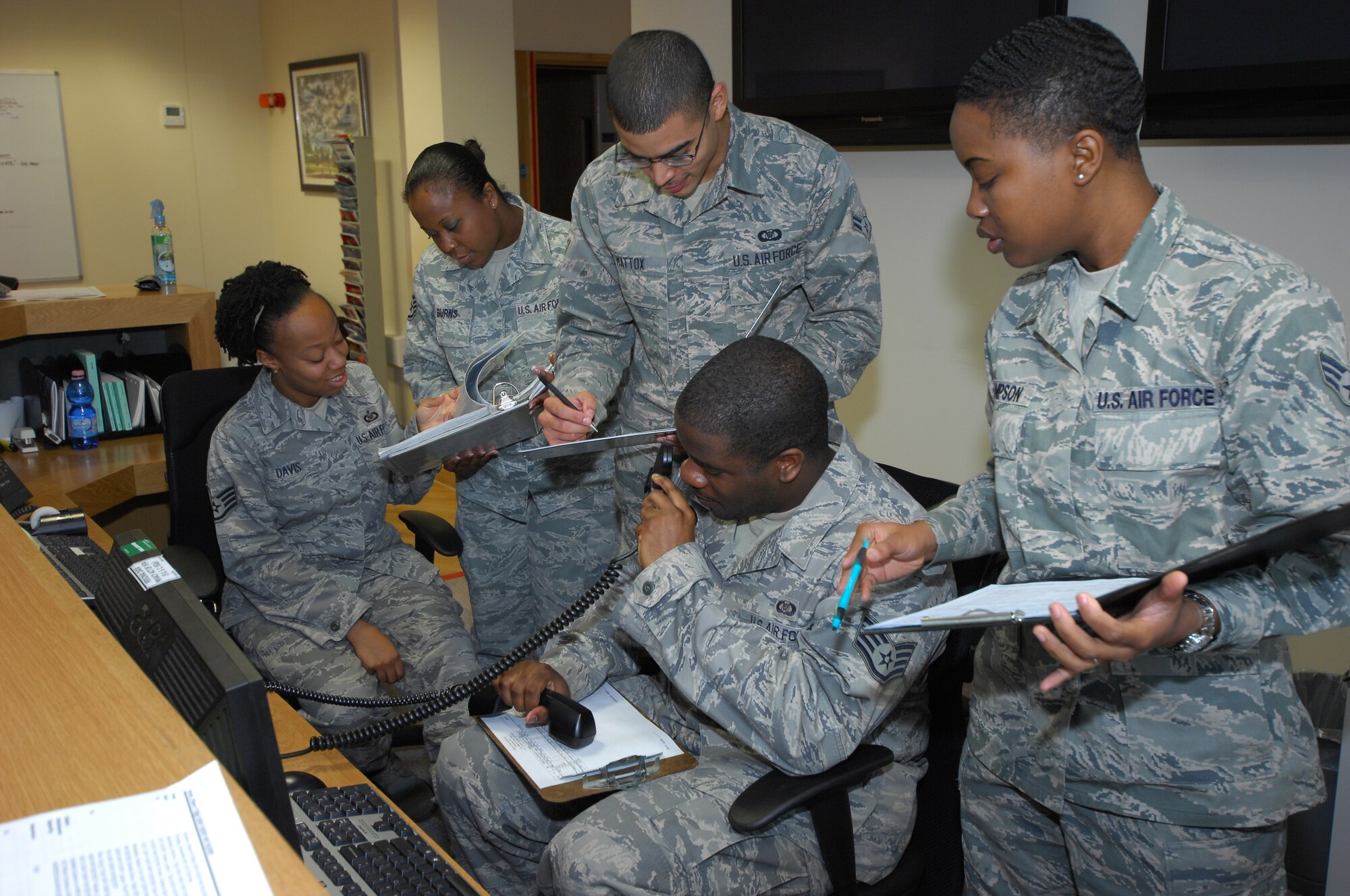 ROAYL AIR FORCE LAKENHEATH, England - Aviation resource managers from the 493rd Fighter Squadron work at the front desk of the 493rd FS building Nov. 9, 2012. Aviation resource managers ensure aircrew are trained, equipped and ready to sustain flight missions. (U.S. Air Force photo by Airman 1st Class Dana Butler)