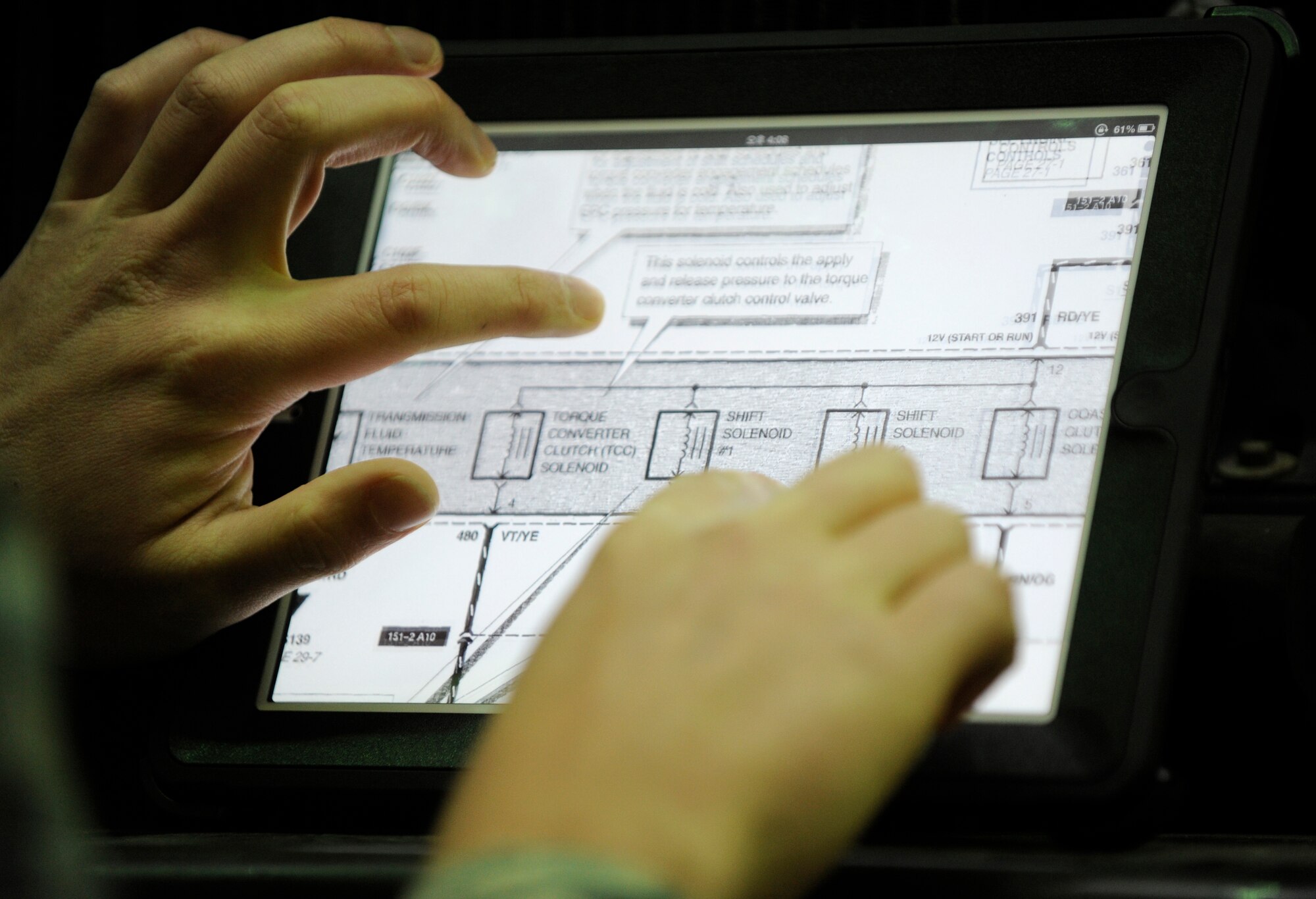 Senior Airman Andrew Radcliff, 8th Logistics Readiness Squadron tech support specialist, demonstrates the ease with which schematics in digital technical orders can be viewed at Kunsan Air Base, Republic of Korea, Nov. 13, 2012. The tablets purchased by the vehicle management flight are just one way Air Force units are using technology to save time, money and manpower.(U.S. Air Force photo/Senior Airman Brigitte N. Brantley)
