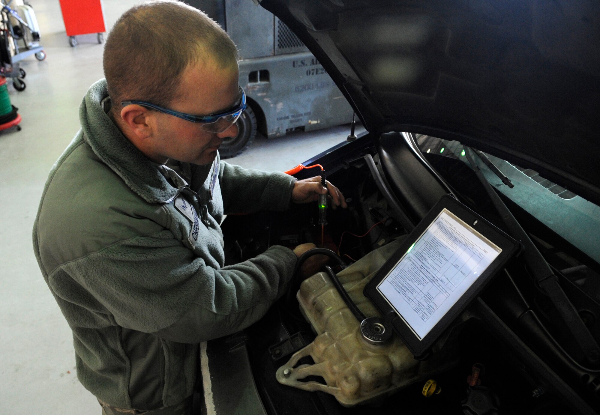 Senior Airman Matt Chesnavage, 8th Logistics Readiness Squadron vehicle management journeyman, tests the power in a motor blower while referencing a technical order at Kunsan Air Base, Republic of Korea, Nov. 1, 2012. The tablets cut down the time it takes for a mechanic to find a reference while troubleshooting vehicles from hours to just minutes. (U.S. Air Force photo/Senior Airman Brigitte N. Brantley)