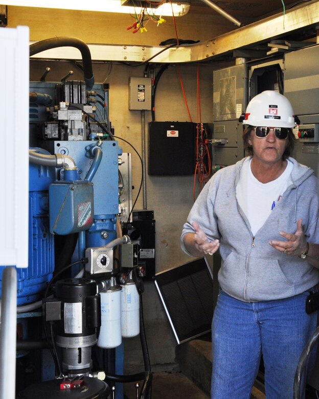 Billie Boyd, lockmaster at U.S. Army Corps of Engineers Nashville District’s Cheatham Lock, explains the function of the upper land wall machinery house to a USACE videographer Nov. 13, 2012. The lock was closed for one month to permit major maintenance repairs to hydraulic and mechanical equipment damaged during the 2010 flood along with other routine maintenance.  (USACE photo by Fred Tucker)