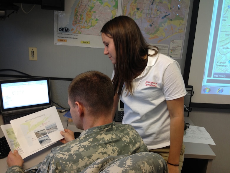 BROOKLYN, N.Y. – Katy Batista, a Norfolk District Geographic Information Systems specialist, goes over a product she created to assist mission managers determine the best way forward in how to direct on the ground activities for the Hurricane Sandy response efforts. The U.S. Army Corps of Engineers has more than 3,000 employees from the North Atlantic Division with an additional 990 team members deployed from other USACE divisions across the Nation engaged to support the response mission. USACE currently has 68 FEMA Mission Assignments exceeding a total of $254 million. (U.S. Army photo/Patrick Bloodgood)