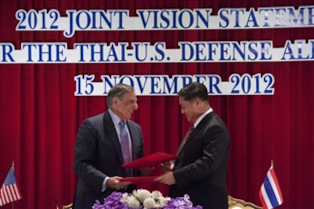 Secretary of Defense Leon E. Panetta and Thailand's Minister of Defence Sukampol Suwannathat exchange copies of a signed joint vision statement in Bangkok, Thailand, on Nov. 15, 2012.  Panetta and Sukampol met earlier to discuss regional security items of interest to both nations and to affirm U.S.-Thailand security ties.  