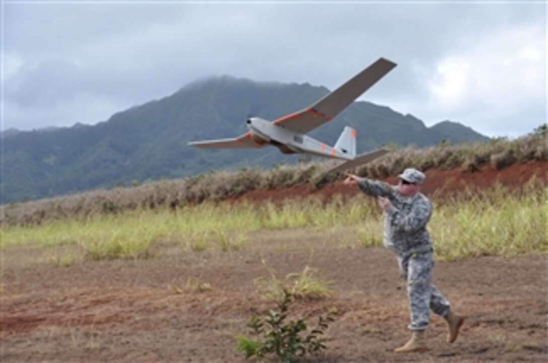 U.S. Army Sgt. Michael Tacket launches a Puma unmanned aerial vehicle during training at Schofield Barracks, Hawaii, on Nov. 14, 2012.  The Puma is used for aerial reconnaissance by troops on the ground.  Tacket is attached to Head Quarters Company, 3rd Brigade Combat Team, 25th Infantry Division.  