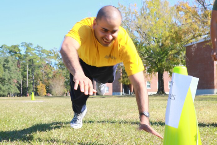 Petty Officer 3rd Class Miguel A. Barboza, a religious program specialist with 2nd Marine Logistics Group, dives the last few feet during a race in the company’s fall safety stand-down aboard Camp Lejeune, N.C., Nov. 5, 2012. Headquarters Co. added team-building events to its itinerary of awareness briefings on issues such as sexual assault and suicide prevention.