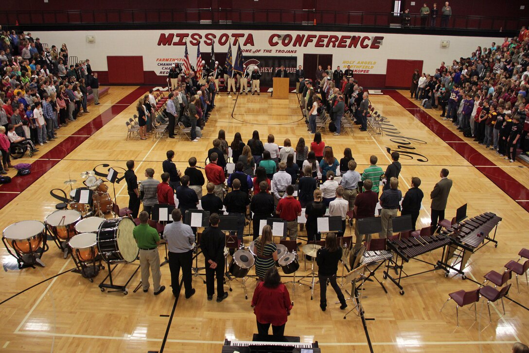 The New Prague High School student body stands for the arrival of the honor guard during the school's Veterans Day ceremony on Nov. 12. Burnsville, Minn., recruiter Sgt. Richard Dibiaso, 32, from Aurora, Ill., addressed the audience during the ceremony.