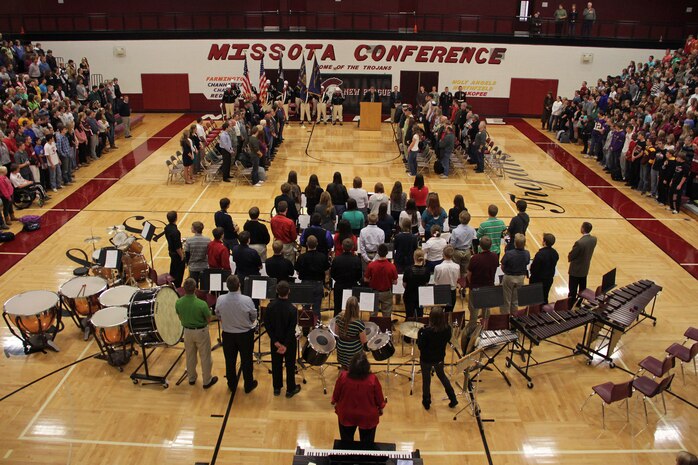 The New Prague High School student body stands for the arrival of the honor guard during the school's Veterans Day ceremony on Nov. 12. Burnsville, Minn., recruiter Sgt. Richard Dibiaso, 32, from Aurora, Ill., addressed the audience during the ceremony.