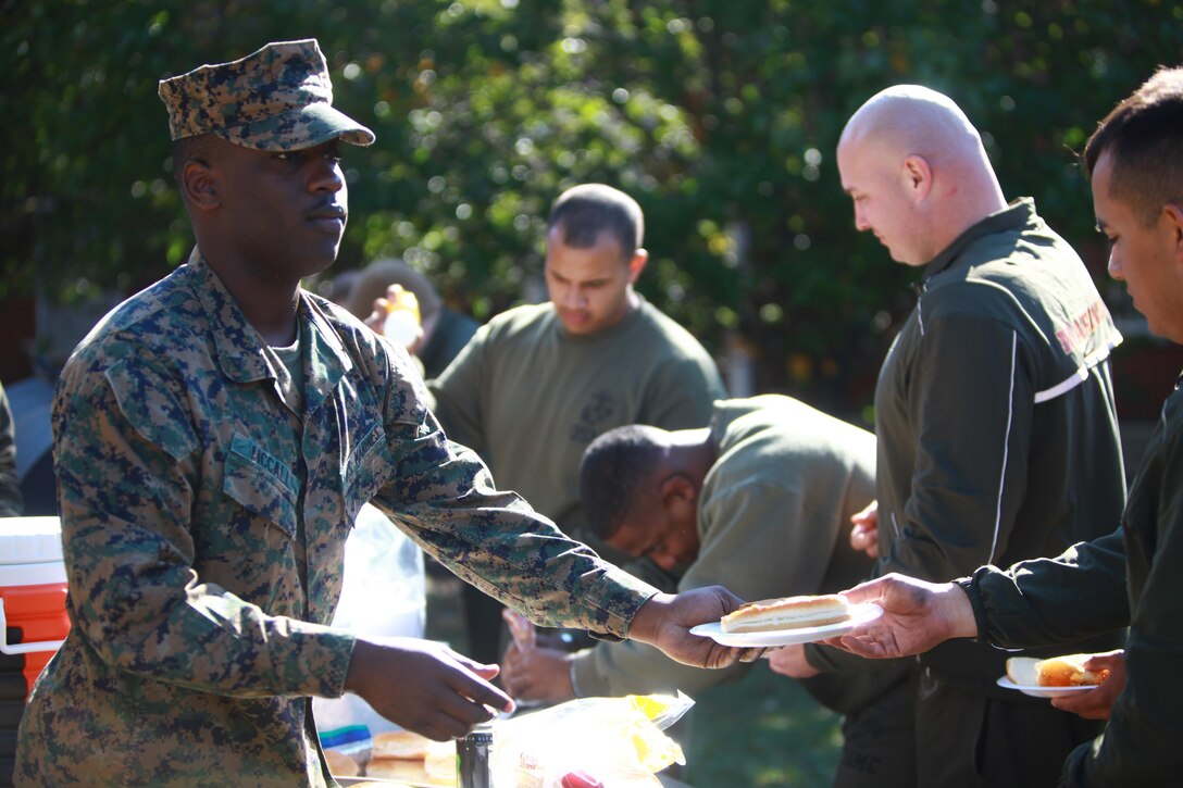 Marines and sailors with Headquarters Company, Combat Logistics Regiment 27, 2nd Marine Logistics Group load their plates with food after several hours of physical exercise and classes aboard Camp Lejeune, N.C., Nov. 5, 2012. The company held a series of classes to increase awareness of issues such as suicide, drug abuse and cold-weather injuries. 
