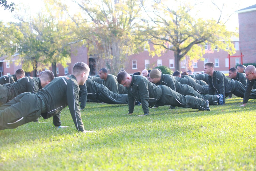 Marines and sailors with Headquarters Company, Combat Logistics Regiment 27, 2nd Marine Logistics Group do push-ups during a safety stand-down aboard Camp Lejeune, N.C., Nov. 5, 2012. Headquarters Co. added a physical aspect to the event to involve the servicemembers more in the annual training classes, which included hazing prevention and driver safety. 
