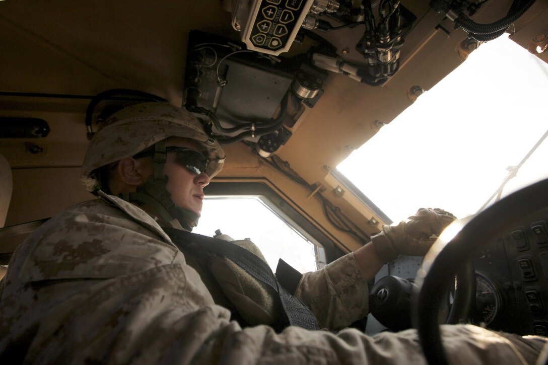 Cpl. Jed Soberal drives the lead vehicle during a mounted convoy patrol at Marine Corps Auxiliary Landing Field Bogue Oct. 18. Soberal, who normally serves as a MAGTF planner, is scheduled to deploy to Afghanistan as member of a Security Force Assistance Adviser Team.