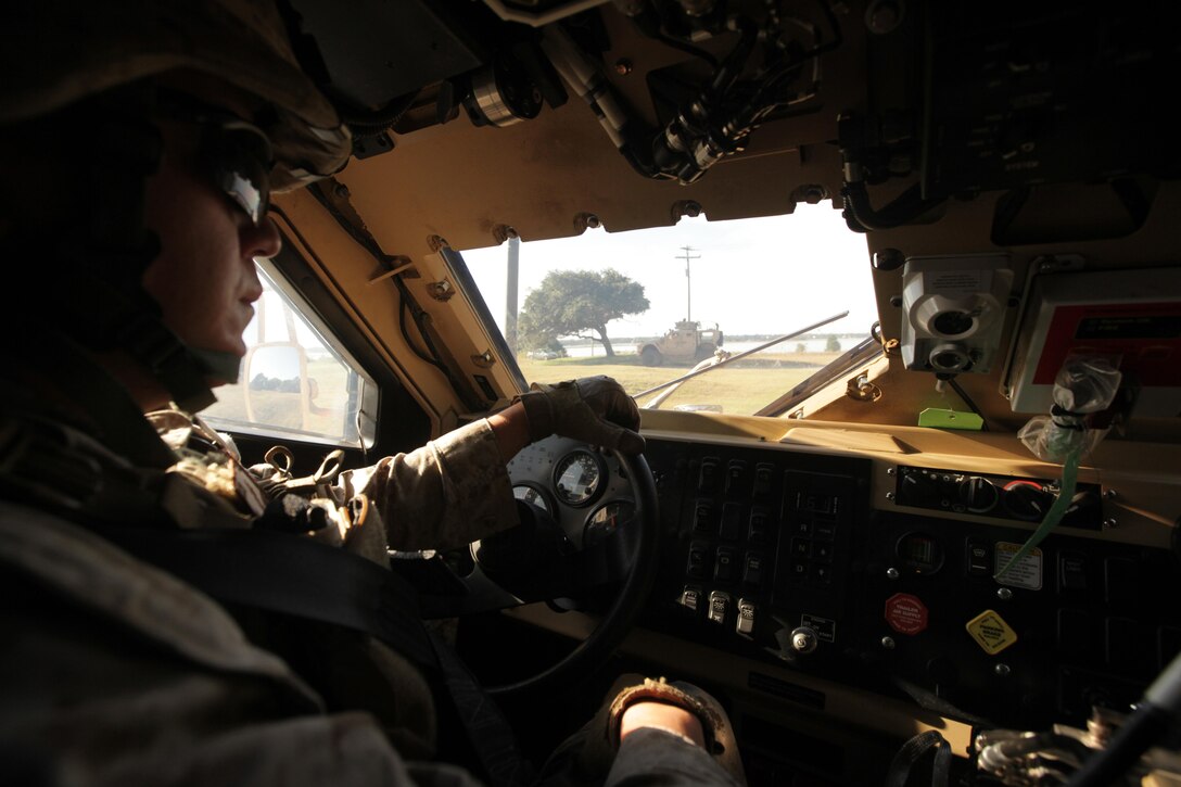 Cpl. Jed Soberal drives the lead vehicle during a mounted convoy patrol at Marine Corps Auxiliary Landing Field Bogue Oct. 18. Soberal, who normally serves as a MAGTF planner, is scheduled to deploy to Afghanistan as member of a Security Force Assistance Adviser Team.
