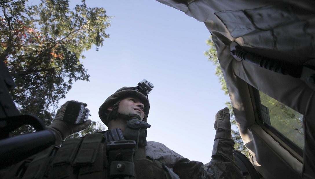 Capt. James Slocum calls in an improvised explosive device during a mounted convoy patrol at Marine Corps Auxiliary Landing Field Bogue. Oct. 18. As a turret gunner, Slocum's job is to detect IEDs. Slocum is a member of a Security Force Assistance Adviser Team (SFAAT) which is scheduled to deploy to Afghanistan in support of II Marine Expeditionary Force (Forward).