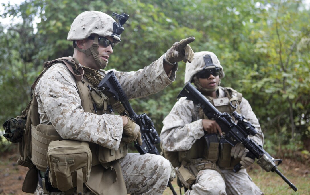 Maj. Isaiah Martinez directs Capt. Wynndee Young to assault the enemy after receiving direct fire during a foot patrol exercise at Marine Corps Auxiliary Landing Field Bogue Oct. 18. The Marines are members of a Security Force Assistance Adviser Team preparing for an upcoming deployment to Afghanistan.
