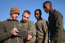 Team one from Headquarters and Support Company review the tasks in each of the three phases before starting the Chemical Biological Incident Response Force Commander’s Challenge on Nov. 6. Twelve teams of four competed in the challenge for bragging rights and a little extra liberty. The challenge to not only tested physical strength and endurance but their knowledge base of CBRNE consequence management as well. (Official Marine Corps photo by Sgt. Frances L Goch, Released)