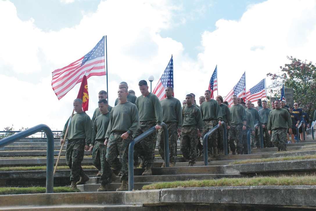 More than 35 Marines from Marine Depot Maintenance Command, Marine Corps Logistics Command and Marine Corps Logistics Base Albany march into the Albany Veterans Park Amphitheater after participating in the 8th annual Operation One Voice run.