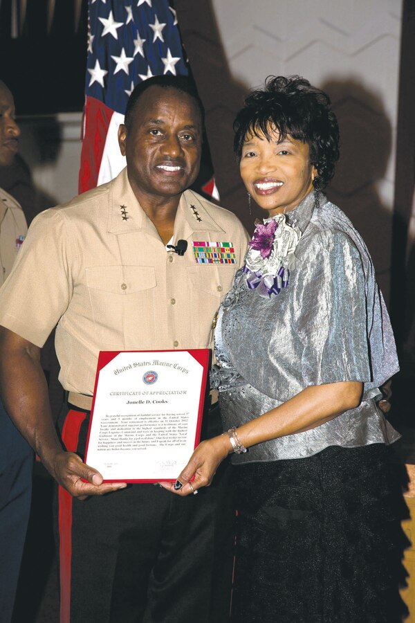 Lt. Gen. Willie Williams, director, Marine Corps Staff, Washington, D.C., stands with Jonelle Cooks after her recent retirement at the Base Chapel.
