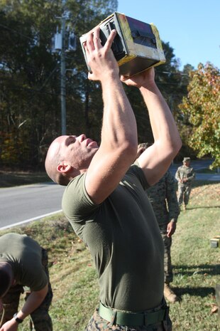 Cpl. Phillip McMahon pushes out ammo can lifts with his team during the first phase of the Chemical Biological Incident Response Force Commander’s Challenge on Nov. 6. Each team of four had to complete 600 ammo-can lifts for the first phase physical task of the challenge. (Official Marine Corps photo by Sgt. Frances L Goch, Released)